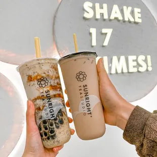 a hand holding a cup of bubble tea