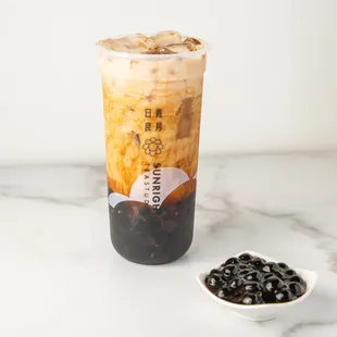 a cold drink and a bowl of black beans