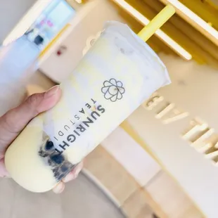 a hand holding a cup of bubble tea