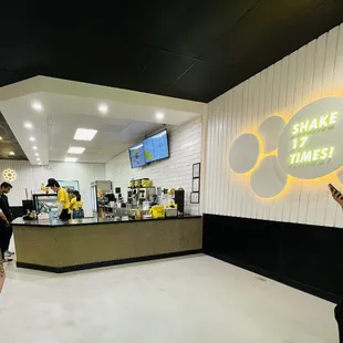 a woman holding a sign that says shake it times