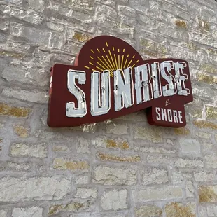 a sign on a brick wall