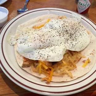 Eggs over easy atop hash browns with ham. Very good!