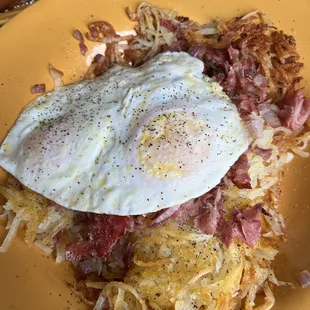 Corned beef hash with two over easy eggs.
