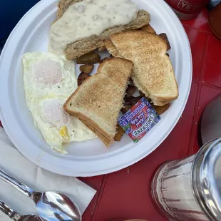Eggs over easy with chicken fried steak , toast