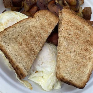 Eggs over easy toast and potatoes