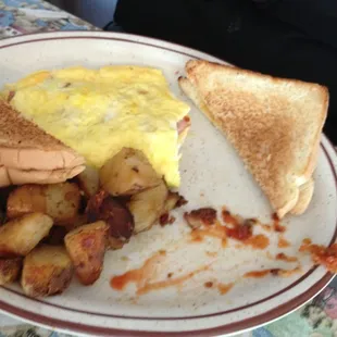 Ham and cheese omelet with toast and hash browns.