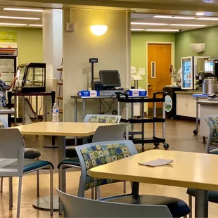 the interior of a restaurant with tables and chairs