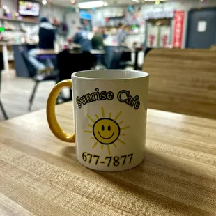 a coffee mug with a smiley face on it