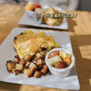 a breakfast of eggs, potatoes and fruit