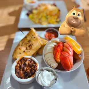 a plate of food with a bear figurine