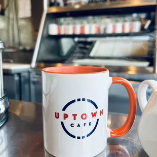 a coffee pot and a mug on a counter