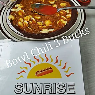 a bowl of chili and a hot dog