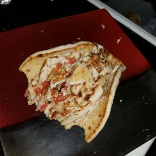 Grilled chicken pita wide open and ready to be eaten
