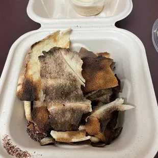 Burned, literal pita crumbs. Like someone shook out the toaster and served it to a customer. Disappointing