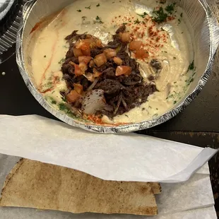 a bowl of soup and pita bread