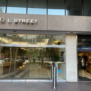 Sunrise Deli entrance is the door on the right. This building is on the corner of L and 13th.