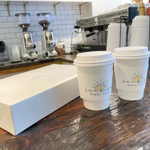 two coffee cups and a box