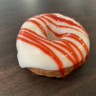 a glazed donut with red and white icing