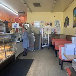 a woman standing in front of the counter