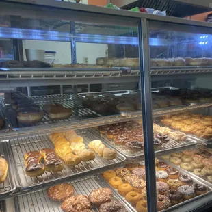 a variety of donuts in a display case