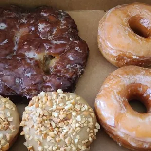 Apple fritter, glazed donuts and peanuts with maple glazed.