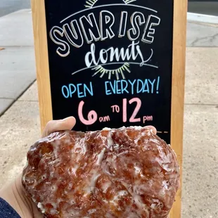 a hand holding a donut