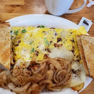 an omelet with onions and toast