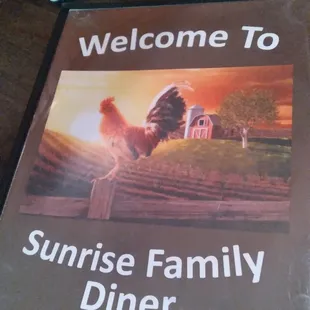 a rooster on a fence