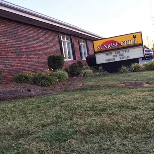 a sign in front of a brick building