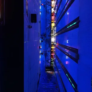 a narrow alley with a blue light