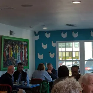 a group of people sitting at tables in a restaurant