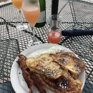  plate of french toast with bacon and eggs