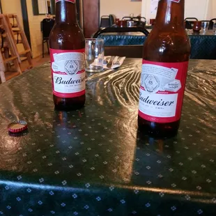 two beer bottles on a table