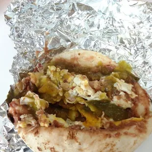 Bacon, eggs and beans on flour with a bunch of their green sauce. Would love to take a bottle of sauce home with me.