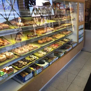 a variety of donuts in a display case