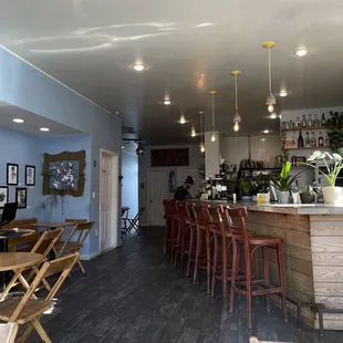 a bar with wooden tables and chairs