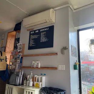 a coffee shop with a menu on the wall