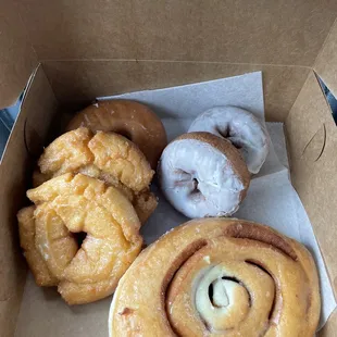 Glazed Cinnamon Roll, Vanilla Iced Cake, Glazed Raised, and Old Fashioned