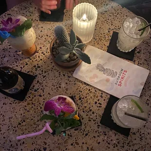 a table with cocktails and a menu