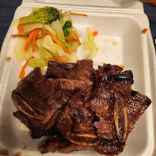 meat and vegetables in a styrofoam container