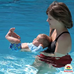 Infant swim lessons - student practices floating on their back