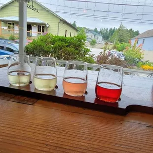a row of glasses of wine on a table