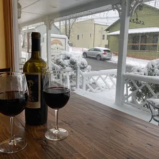 two glasses of wine and a bottle of wine