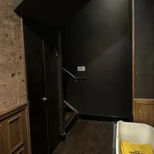 The stairwell in the pizza parlor to the bar