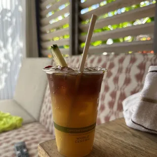 a cup of iced tea with a straw and a straw in it