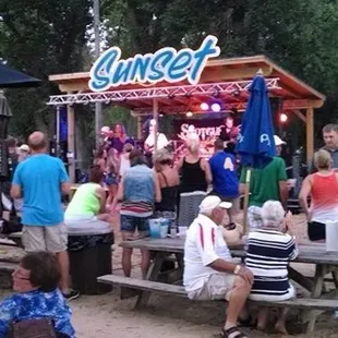 a group of people sitting at picnic tables