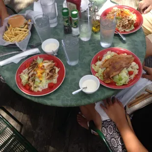 From left to right--mango chicken sandwich, jerk chicken salad with mango salsa, fish on top of salad, jerk chicken salad