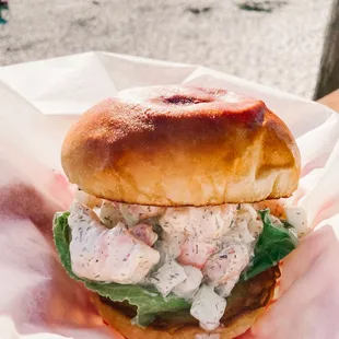 Savory and creamy shrimp salad sandwich with citrus notes on a pillowy brioche bun.