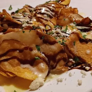 Homemade chips with blue cheese and balsamic glaze.