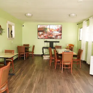 dining area with wood floors and green walls